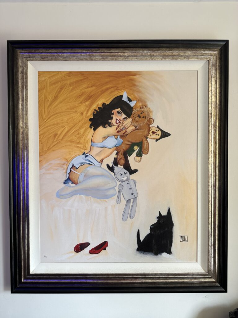 Silly Dreams' by Todd White, an embellished canvas depicting a scantily clad brunette in light blue underwear, lying on a bed cuddling stuffed toys of the Tin Man, Lion, and Scarecrow from Wizard of Oz, with red slippers on the floor.