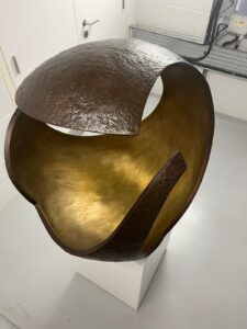 Modern bronze sculpture with an open, spherical design by Vera Borghgraef