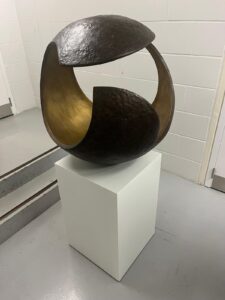 abstract bronze sculpture with circular opening