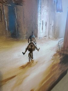 painting of a person giving another person a piggyback ride on a bicycle down a sloped street