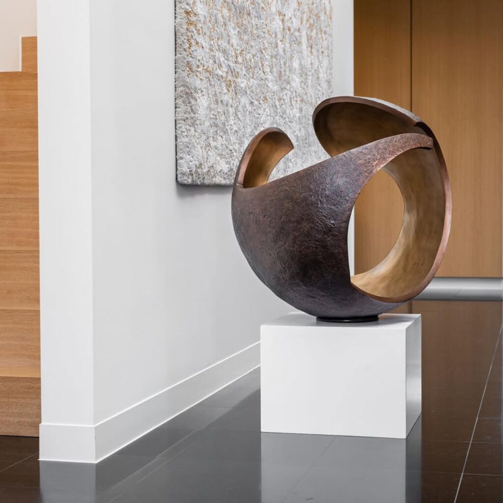 abstract sculpture titled 'Enclose' by Vera Borghgraef displayed on a white pedestal