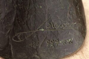 close-up of artist signature on sculpture