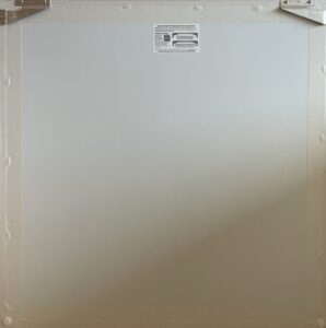 backside of an art canvas with visible frame edges and a label