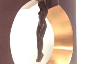 sculpture of a male figure suspended from an arch, titled 'Gravity Male' by Lorenzo Quinn