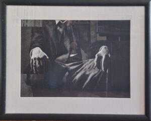 monochrome artwork of a suited man sitting with hands resting on knees