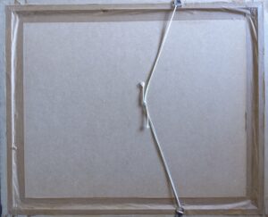 back of a framed artwork with attached string for hanging