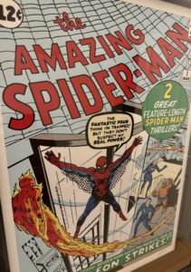 Cover of 'The Amazing Spider-Man #1' comic book featuring Spider-Man swinging between buildings and two other superheroes on the side.