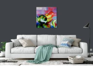 A modern living room with a grey sofa and a colorful abstract artwork titled 'Emerald Marble' by Sarah Graham on the wall.
