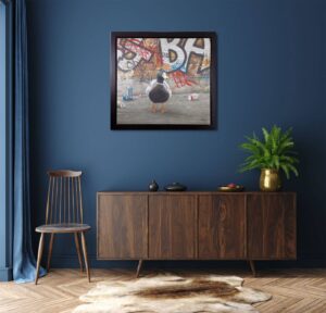 framed painting of a duck in front of graffiti on a wall in modern living room setting