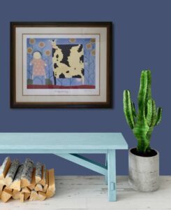 framed artwork of a person with a cow and sunflowers