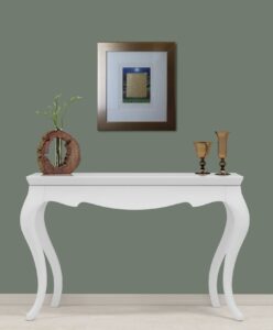 artwork titled 'Golden Sheep' by Mackenzie Thorpe on a wall above a white table