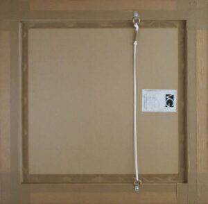 back view of framed artwork with hanging wire and label