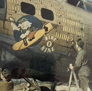 Vintage aircraft nose art with cartoon character and pilots painting tally marks