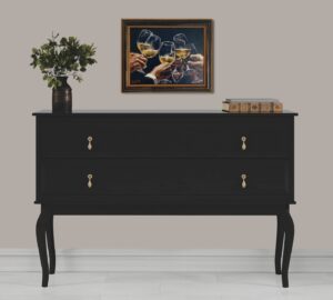 artwork titled 'For a better life III by Fabian Perez displayed above a black chest of drawers