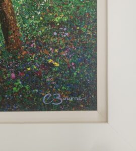 close-up of artwork featuring the artist's signature in the bottom corner