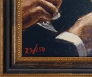 close-up of a framed artwork showing hands and a portion of a suit with the edition number 23/150