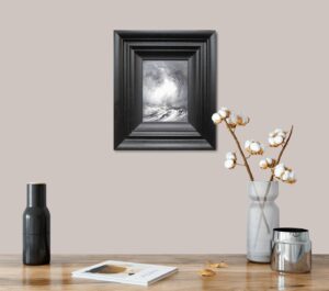Framed artwork titled 'Surging Waters III' by Chris and Steve Rocks displayed on a shelf alongside vases and a magazine.