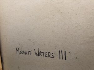 close-up view of the artwork title 'Moonlit Waters III' handwritten on canvas