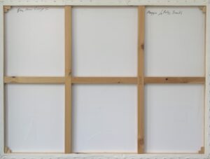 back view of a canvas with wooden frame and artist's signature