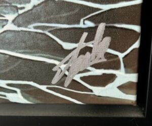 close-up of artwork canvas with artist's signature
