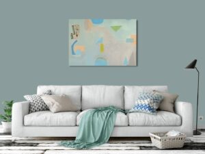 abstract painting with blues, greens, and oranges above a white couch